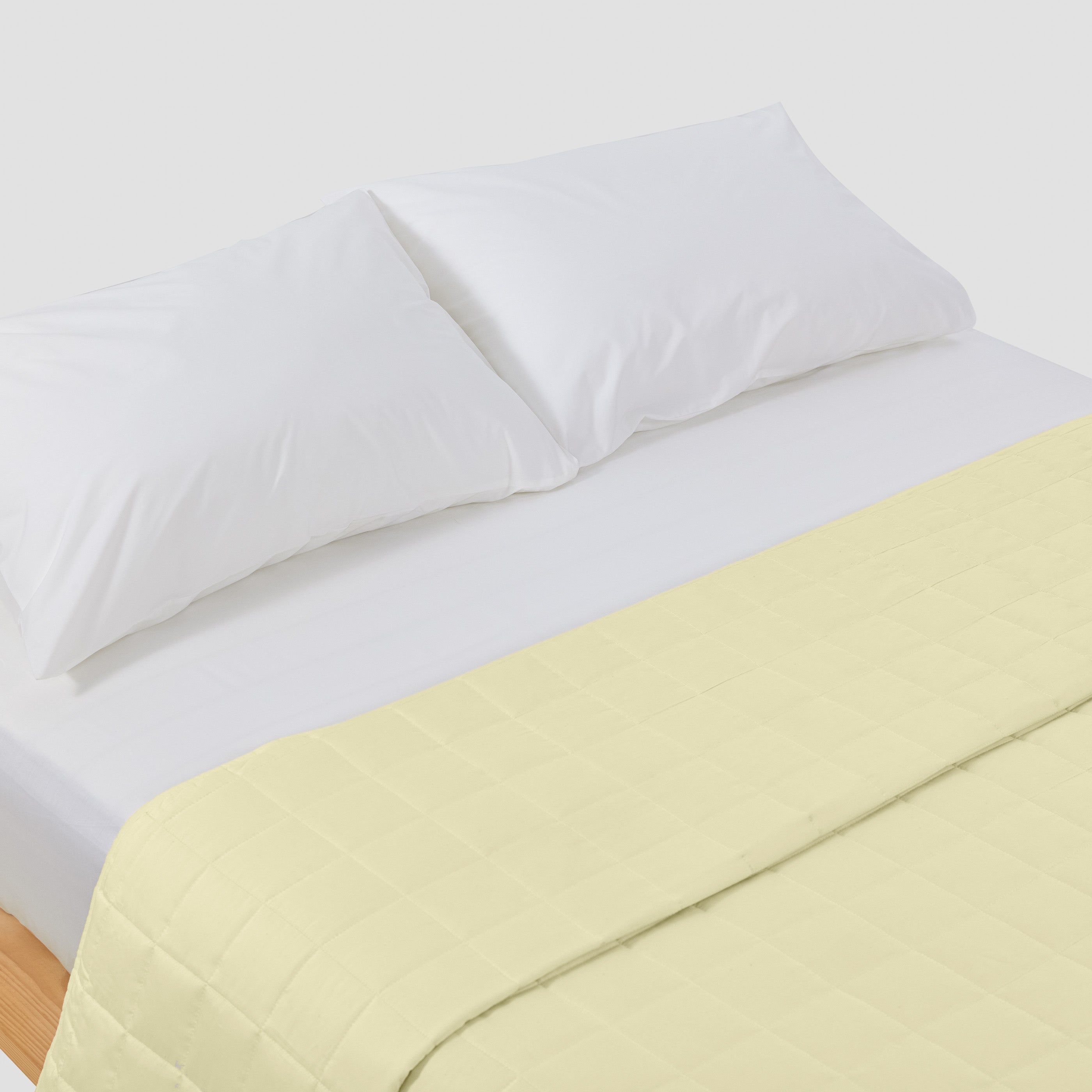 organic-cotton-quilt-in-butter-colour-on-a-bed-by-sojao